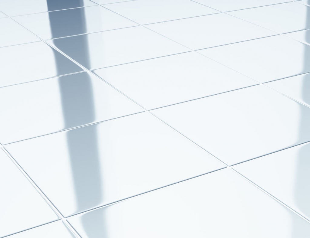 Clean white ceramic tiles on bathroom floor.